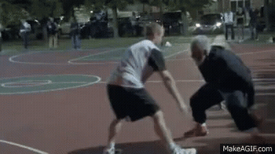 Two Men Are Playing Basketball On A Court With A Referee . GIF