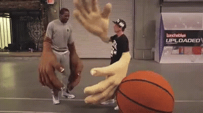 Two Men Are Playing Basketball On A Court With A Sign That Says Lunchables Uploaded On It GIF