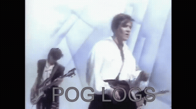 Two Men Are Playing Guitars In Front Of A White Wall With The Words Pog Logs Written On The Bottom . GIF