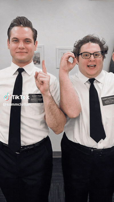 Two Men Are Posing For A Picture And One Has A Name Tag That Says Sammcstellar GIF