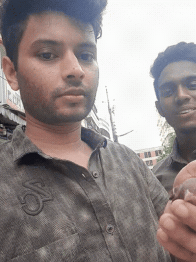 Two Men Are Posing For A Picture And One Has The Letter S On His Shirt GIF