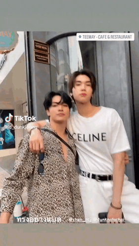 two men are posing for a picture and one of them is wearing a celine shirt