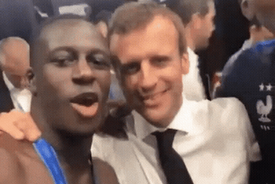 Two Men Are Posing For A Picture Together And One Of Them Is Wearing A Shirt That Says France . GIF
