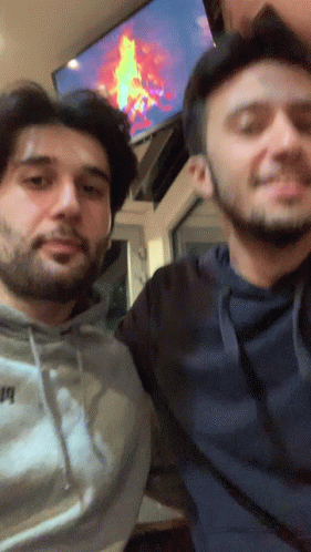 Two Men Are Posing For A Picture With One Wearing A Hoodie That Says ' Puma ' GIF