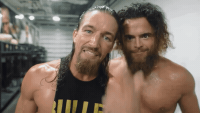Two Men Are Posing For A Picture With One Wearing A Shirt That Says Bullet GIF