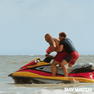 Two Men Are Riding A Jet Ski In The Ocean With The Word Baywatch On The Bottom . GIF