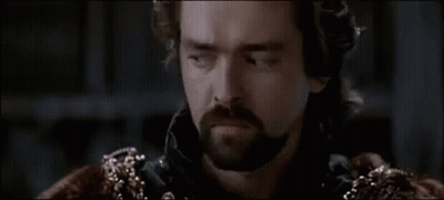 Two Men Are Shaking Hands In A Dark Room In A Movie . GIF