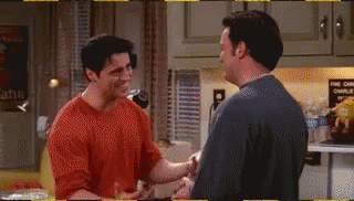 Two Men Are Shaking Hands In A Kitchen In A Friends Episode . GIF