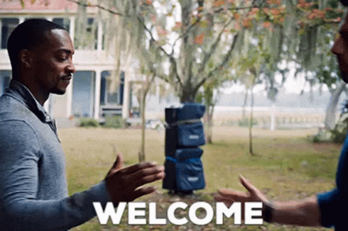 Two Men Are Shaking Hands In Front Of A House And The Word Welcome Is Written On The Screen . GIF