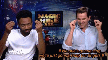 Two Men Are Singing In Front Of A Magic Mike Xxl Sign GIF
