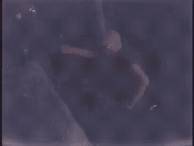 Two Men Are Singing Into Microphones On A Stage . GIF