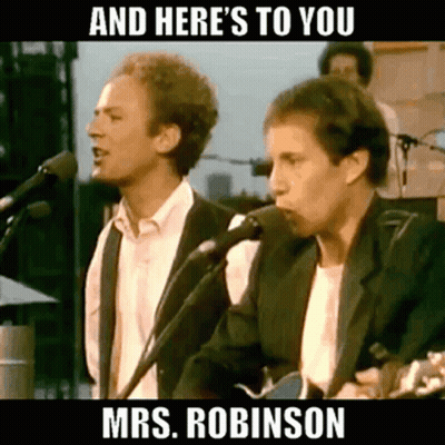 Two Men Are Singing Into Microphones While Playing Guitars On Stage . GIF