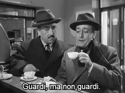 Two Men Are Sitting At A Counter Drinking Coffee And One Of Them Is Saying `` Guardi , Ma Non Guardi '' . GIF