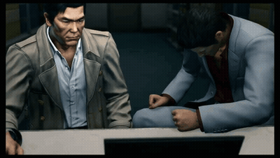 Two Men Are Sitting At A Desk In Front Of A Computer GIF