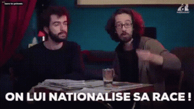 Two Men Are Sitting At A Table With A Glass Of Beer And A Stack Of Papers . GIF