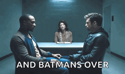 Two Men Are Sitting At A Table With A Woman Behind Them And The Words " And Batmans Over " Are Visible GIF