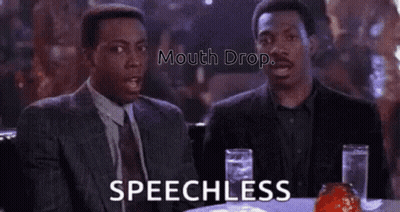 Two Men Are Sitting At A Table With Glasses Of Water And Talking . GIF