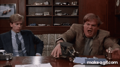 Two Men Are Sitting At A Table With Makeagif.com Written On The Bottom Right GIF