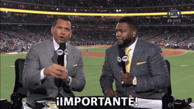 Two Men Are Sitting At A Table With Microphones In Front Of A Baseball Field And One Of Them Is Saying Importante GIF