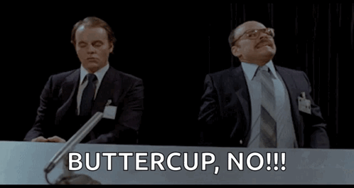 Two Men Are Sitting At A Table With The Words Buttercup No Written On It GIF