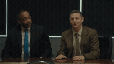 Two Men Are Sitting At A Table With The Words Coward Pig Flick On The Bottom GIF
