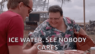 Two Men Are Sitting At A Table With The Words `` Ice Water , See Nobody Cares '' On The Screen . GIF