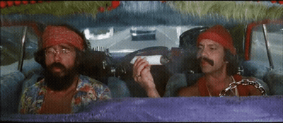 Two Men Are Sitting In A Car And One Is Holding A Cigarette GIF