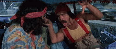 Two Men Are Sitting In A Car And One Is Sticking His Tongue Out . GIF