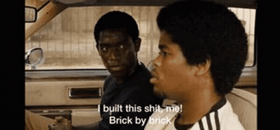 Two Men Are Sitting In A Car And One Of Them Is Saying `` I Built This Shit , Me ! Brick By Brick '' GIF