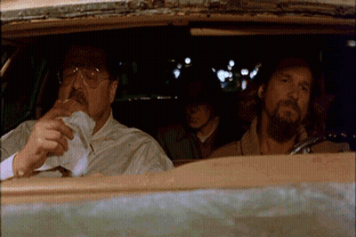 Two Men Are Sitting In A Car One Is Smoking A Cigarette GIF