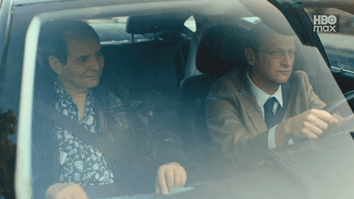 Two Men Are Sitting In A Car With Hbo Max On The Bottom Right GIF