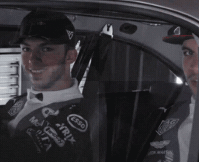 Two Men Are Sitting In A Car With One Wearing A Hat That Says Esso On It GIF