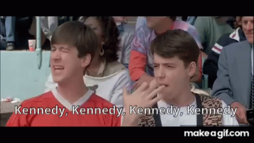 Two Men Are Sitting In A Crowd Of People Watching A Game And One Is Crying . GIF