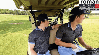 Two Men Are Sitting In A Golf Cart With The Word Roman On The Bottom GIF