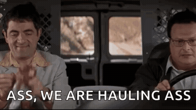Two Men Are Sitting In A Van And One Of Them Is Saying `` Ass , We Are Haulng Ass '' . GIF