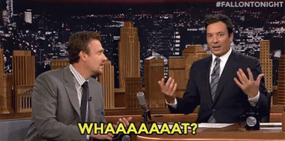 Two Men Are Sitting In Front Of A Microphone And One Of Them Is Saying " Whaaaaaaaat " GIF