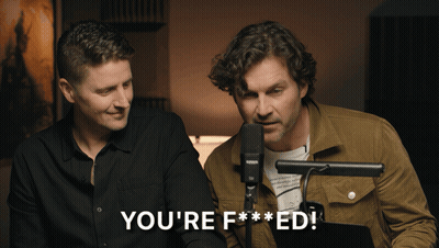 Two Men Are Sitting In Front Of A Microphone With The Words You 'Re F *** Ed GIF