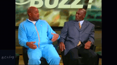 Two Men Are Sitting In Front Of A Screen With The Word Buzz On It GIF