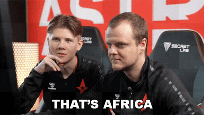 Two Men Are Sitting In Front Of A Sign That Says Secret Lab GIF