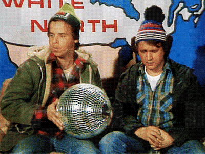 Two Men Are Sitting In Front Of A Sign That Says " White North " GIF