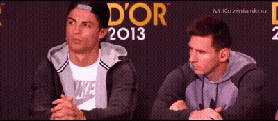 Two Men Are Sitting In Front Of A Wall That Says D' Or 2013 GIF
