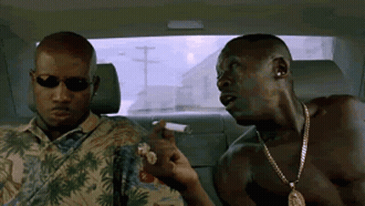 Two Men Are Sitting In The Back Seat Of A Car Smoking Cigarettes And Talking . GIF