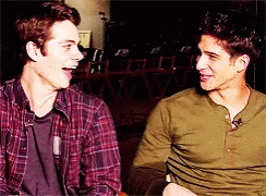 Two Men Are Sitting Next To Each Other And Laughing Together GIF
