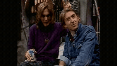 Two Men Are Sitting Next To Each Other And One Is Holding A Beer Can . GIF