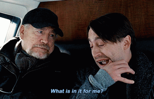 Two Men Are Sitting Next To Each Other And One Of Them Is Asking The Other What Is In It For Me GIF