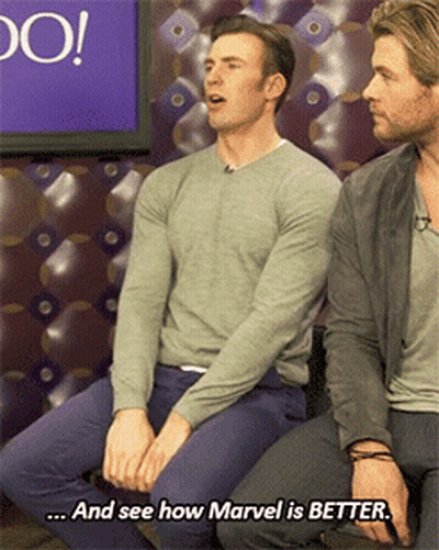 Two Men Are Sitting Next To Each Other And One Of Them Says And See How Marvel Is Better GIF