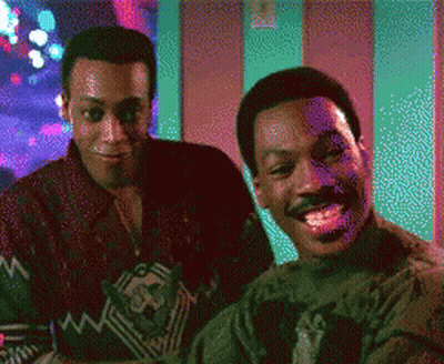 Two Men Are Sitting Next To Each Other And Smiling In A Pixelated Image GIF