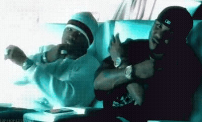 Two Men Are Sitting Next To Each Other In A Car And One Is Wearing A Hat That Says Mlb On It GIF