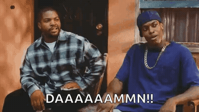 Two Men Are Sitting Next To Each Other In A Chair . GIF