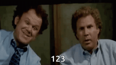 Two Men Are Sitting Next To Each Other In Front Of A Window And Smiling . One Of The Men Is Wearing A Tie . GIF